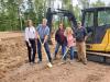 The co-owners of Northshore Laundry Services celebrate construction getting underway. Photo by Rhonda Silence